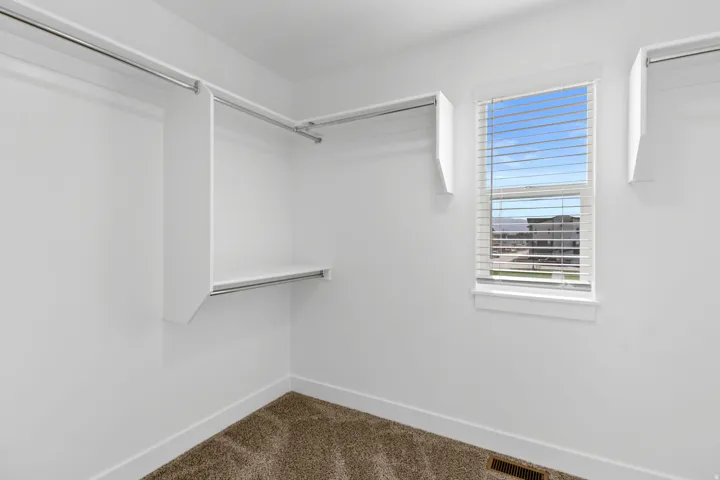 Primary bedroom walk-in closet