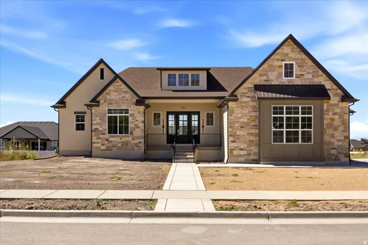 Stone and stucco exterior with dark trim accents