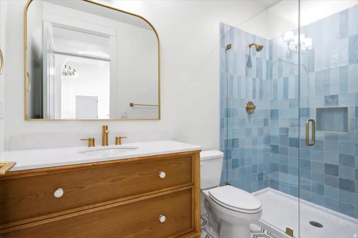 Wood-finish vanity with a white countertop and undermount sink
