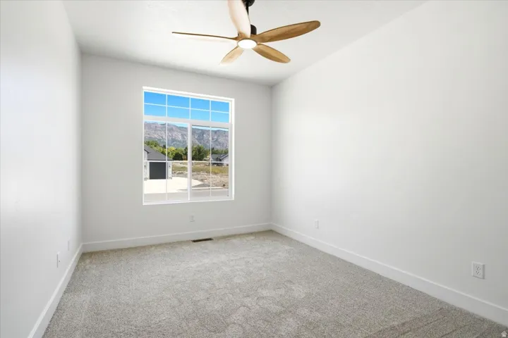Light-colored carpeting with white walls