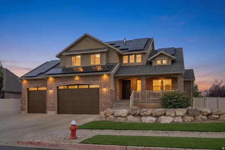 Brick and stucco exterior with multiple roof-mounted solar panels