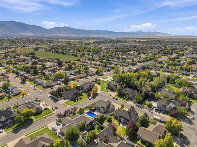 Residential neighborhood with established streets, mature trees, and mountain scenery