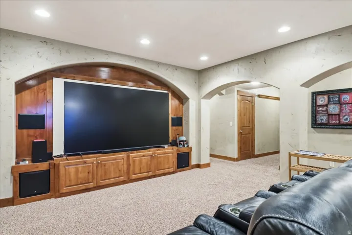 Built-in entertainment center with a large screen and wood-finish cabinetry