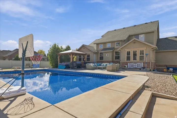 In-ground swimming pool with concrete surround