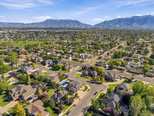 Expansive residential area featuring numerous single-family homes, mature trees, and paved streets