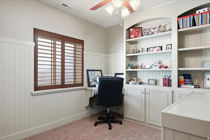 Built-in shelving with arched accents and lower cabinetry