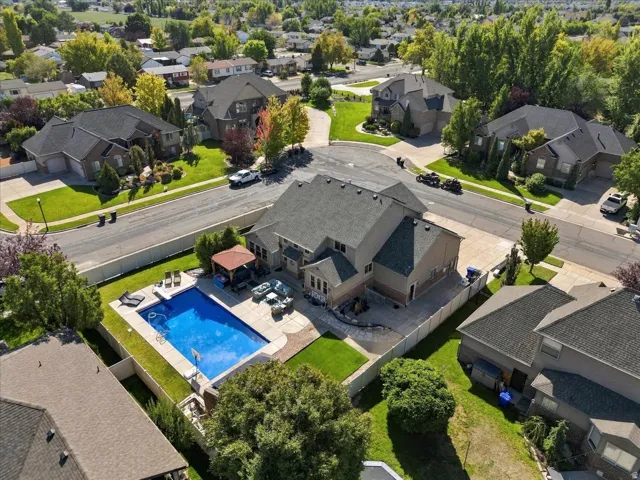 Two-story residence with a multi-gabled roofline, a private swimming pool, a dedicated patio area, and a shaded gazebo