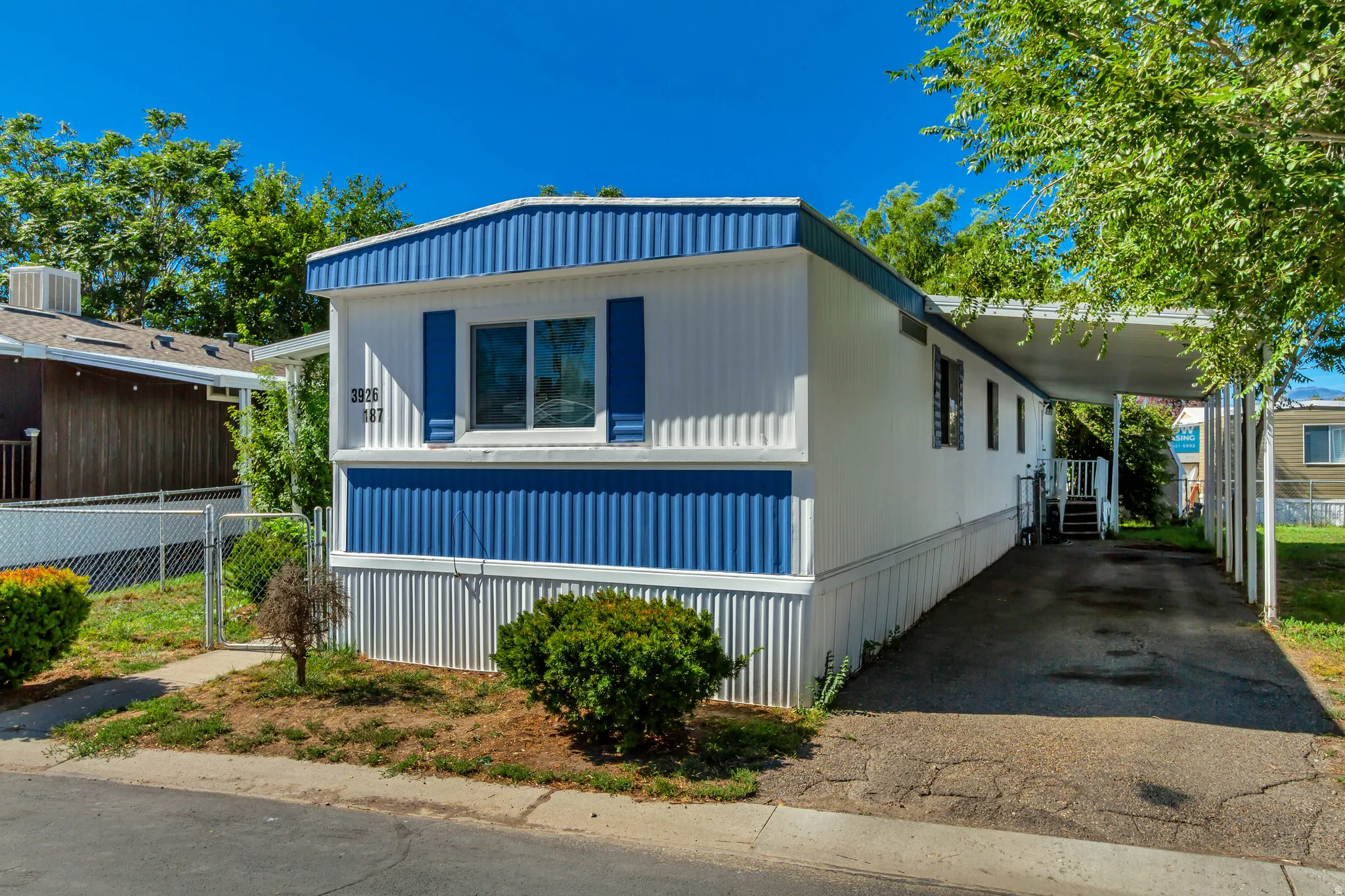 White siding exterior with blue accents and shutters