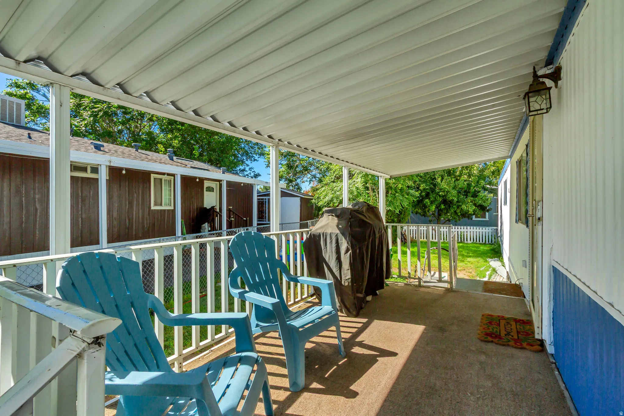 Covered porch featuring a concrete surface and white railing