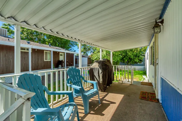 Covered porch featuring a concrete surface and white railing