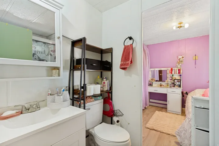 White vanity with an integrated sink and chrome faucet