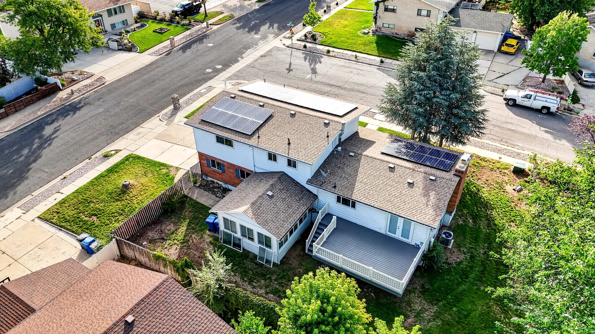 Asphalt shingle roof with multiple solar panel arrays