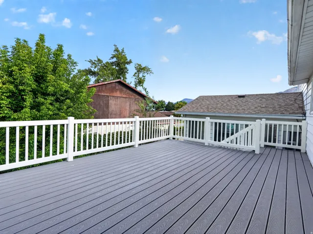 Spacious exterior deck with composite decking and white railing