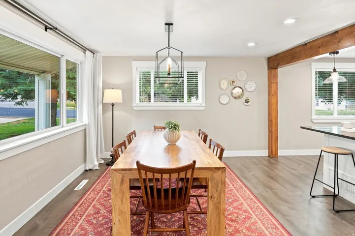 Wood-finish flooring throughout, complemented by a prominent exposed wood beam