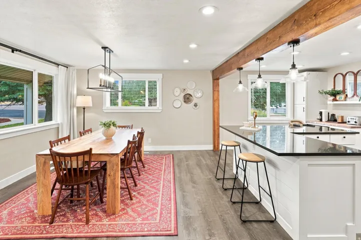 Open concept design featuring a wood-finish flooring, recessed lighting, and a kitchen island with seating