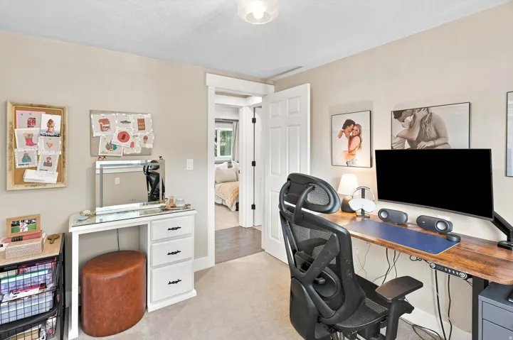 Neutral-toned walls complement the carpeted flooring