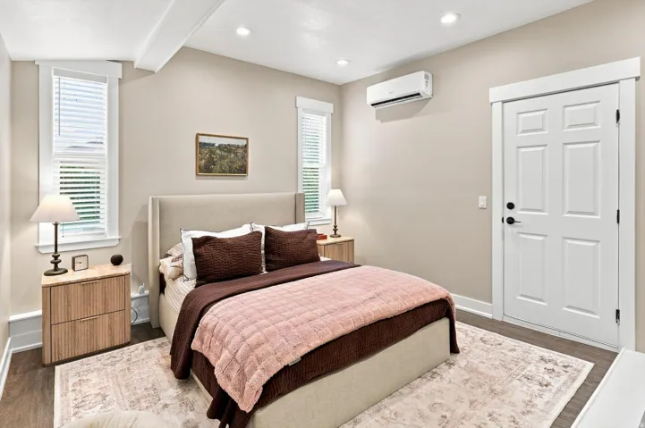 High ceilings featuring exposed beams and recessed lighting