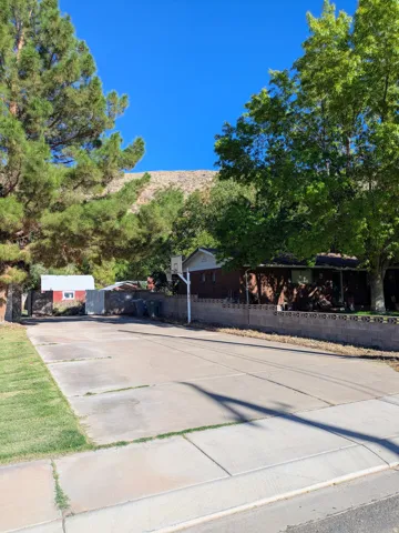 Paved concrete pad with adjacent sidewalk and grass border