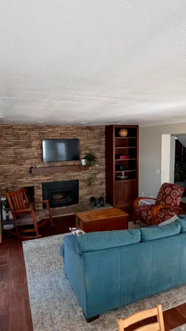 Stone accent wall with wood mantel and fireplace insert