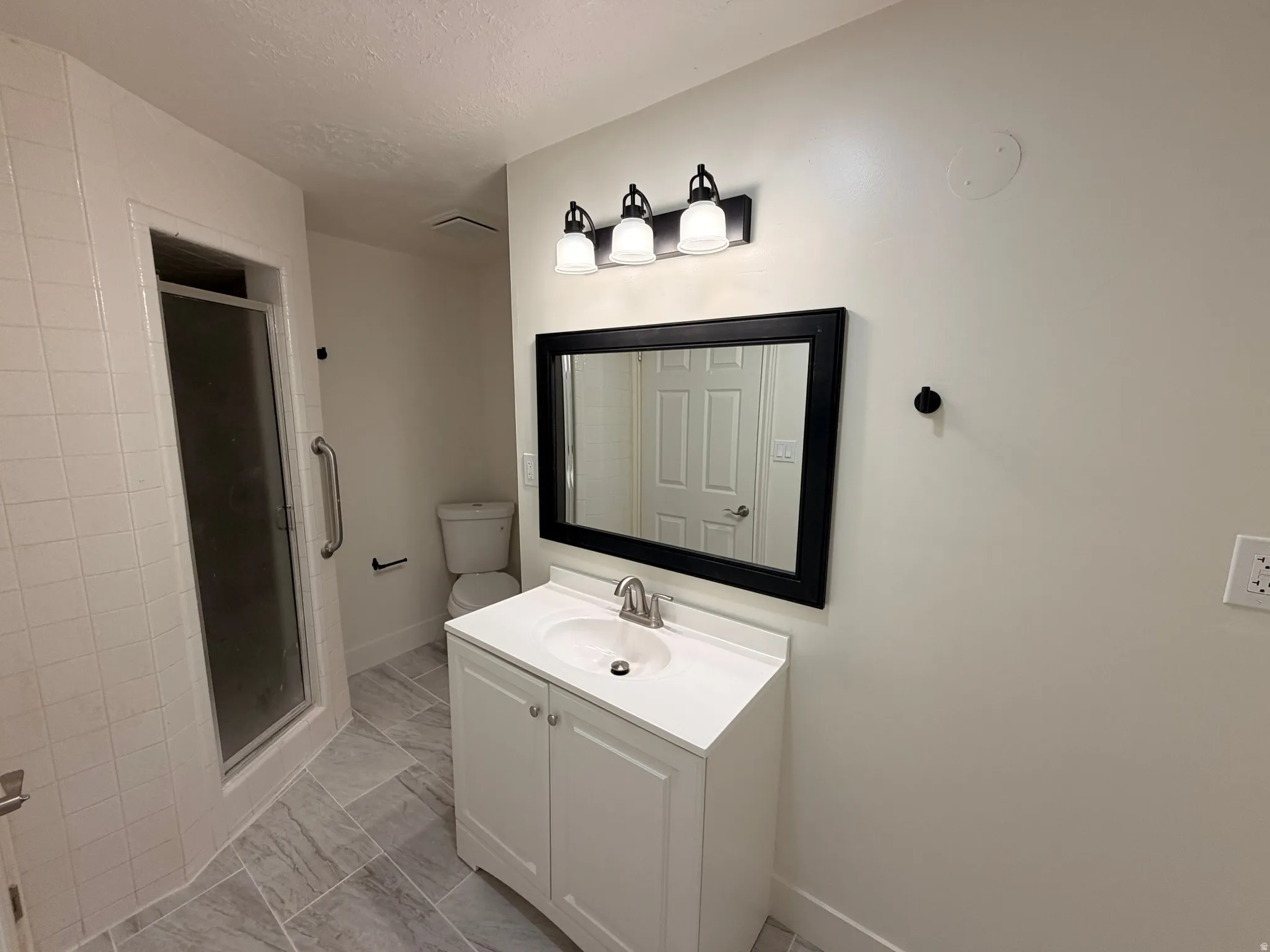 White vanity with an integrated sink and chrome faucet