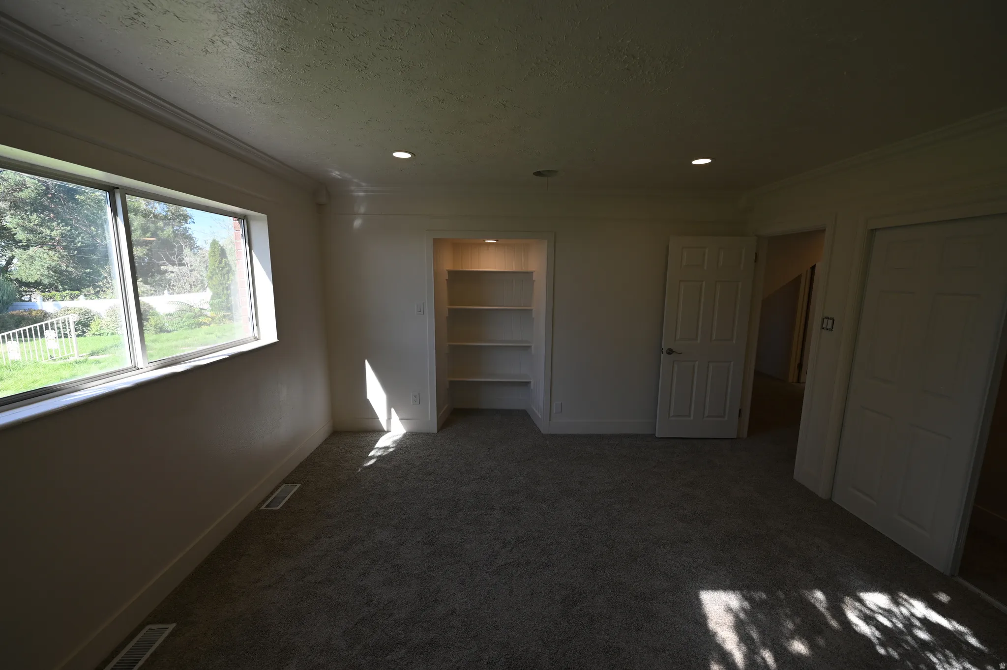 Recessed lighting and a window offering abundant natural illumination
