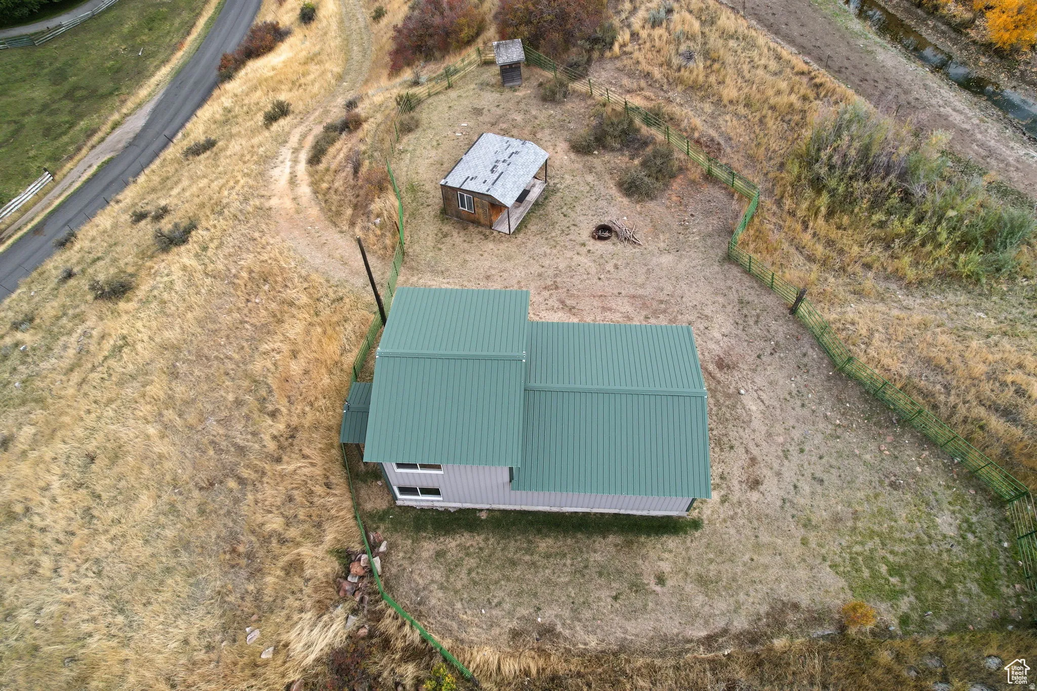 Metal-roofed structure with light-colored siding