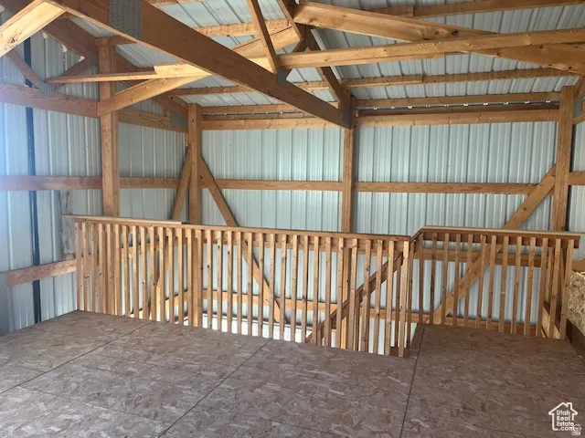 Exposed wood beam construction, wood spindle railing system, sheet metal wall panels, and composite wood flooring