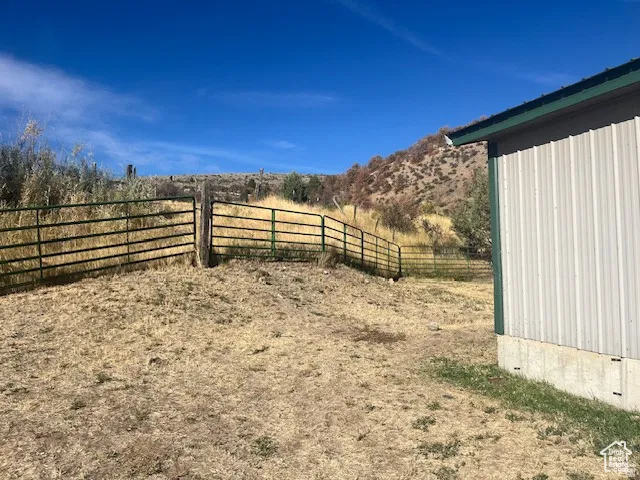 Corrugated metal siding building with a green trim roof and concrete foundation