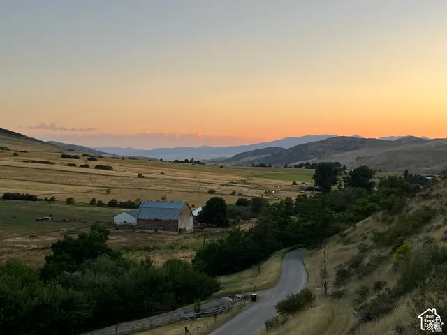Expansive rural landscape featuring rolling hills and distant mountains