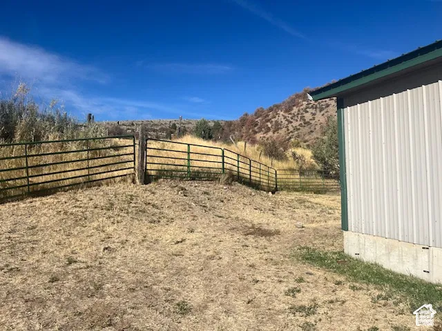 Corrugated metal siding building with a green trim roof and concrete foundation