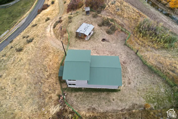Metal-roofed structure with light-colored siding