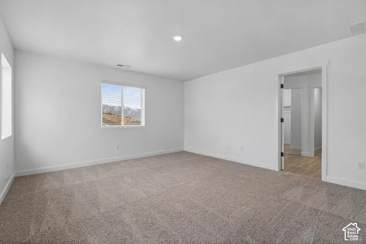 Neutral color palette with white walls and light-toned carpeting