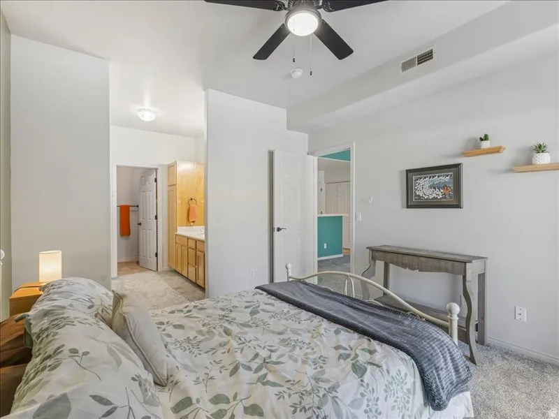 Recessed lighting, ceiling fan, carpeting, and a built-in vanity with cabinetry