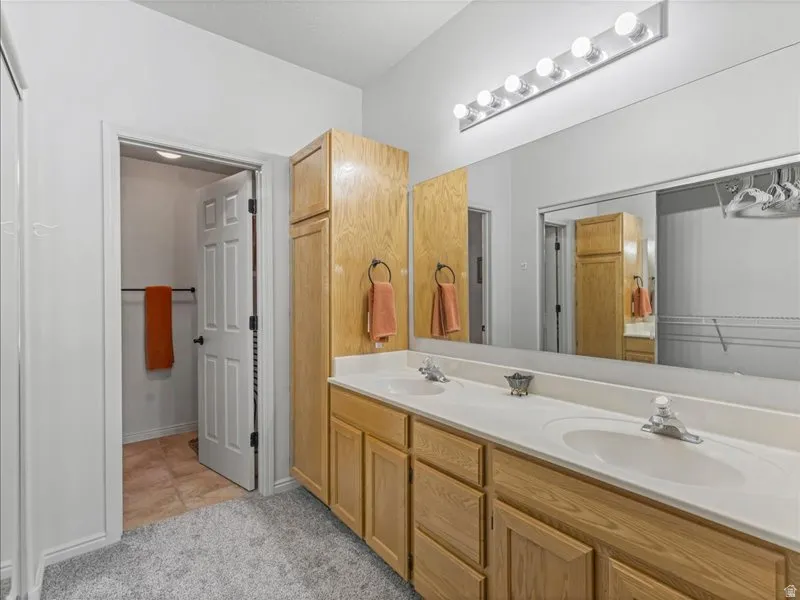 Double vanity with white countertops and integrated sinks