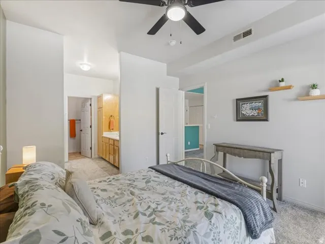 Recessed lighting, ceiling fan, carpeting, and a built-in vanity with cabinetry
