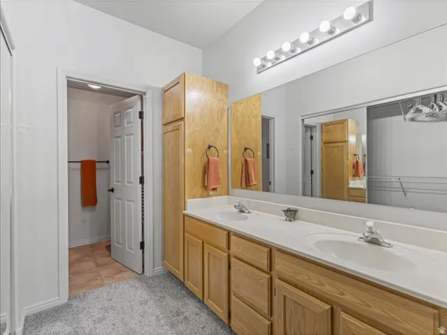Double vanity with white countertops and integrated sinks
