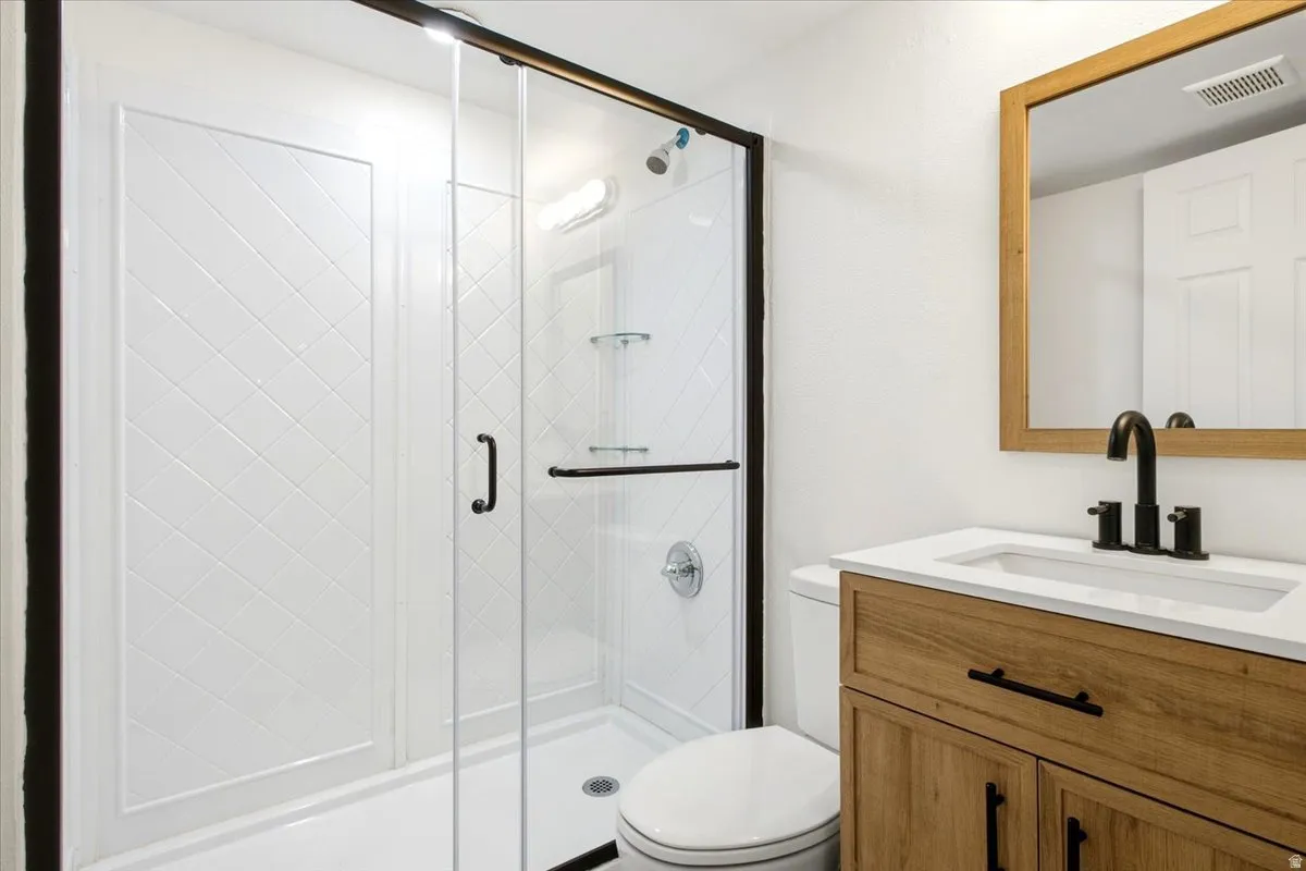 White subway tile shower surround with black-framed glass enclosure
