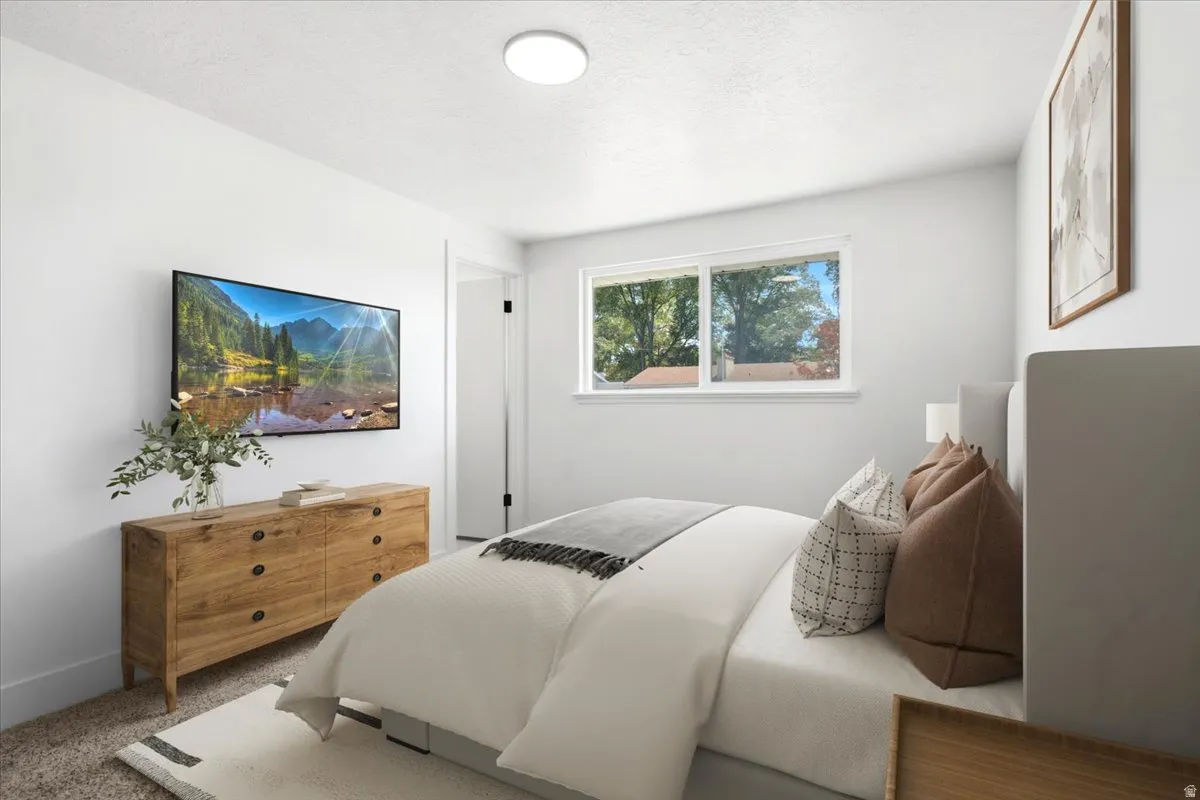 Sleek wall-mounted display, bright overhead lighting, dual pane windows, and neutral wall tones