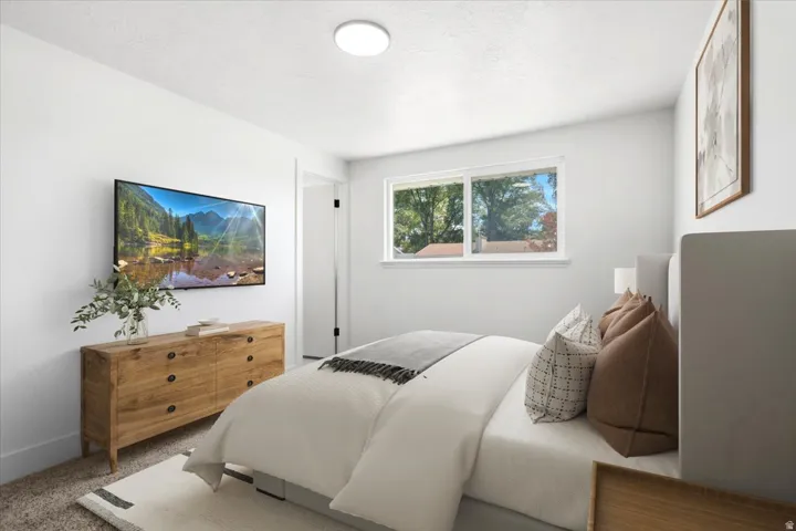 Sleek wall-mounted display, bright overhead lighting, dual pane windows, and neutral wall tones