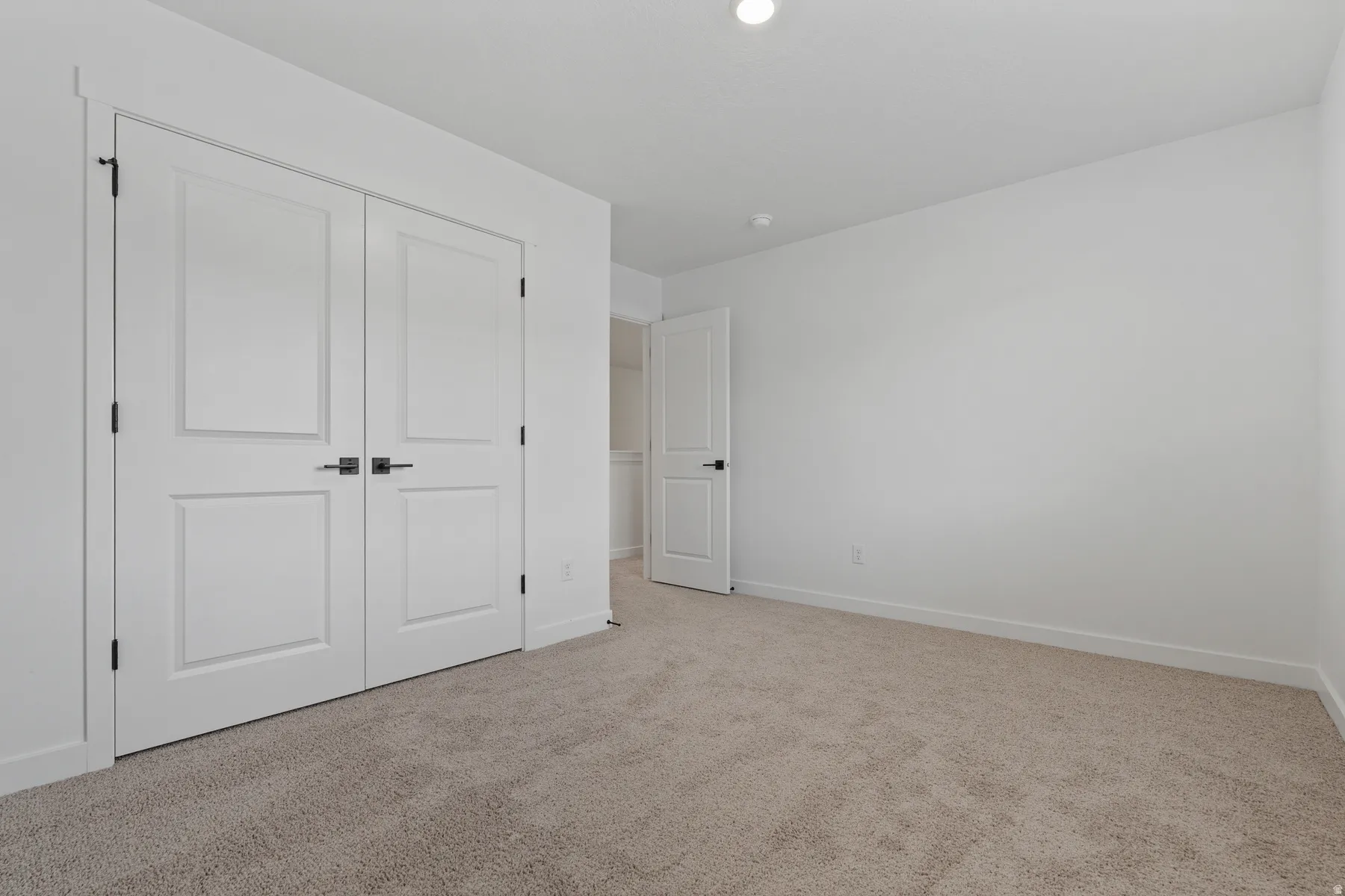Neutral tone wall finish with recessed lighting