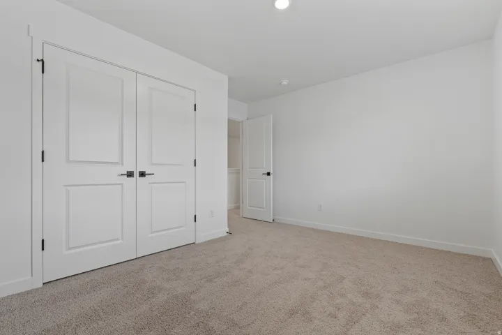 Neutral tone wall finish with recessed lighting
