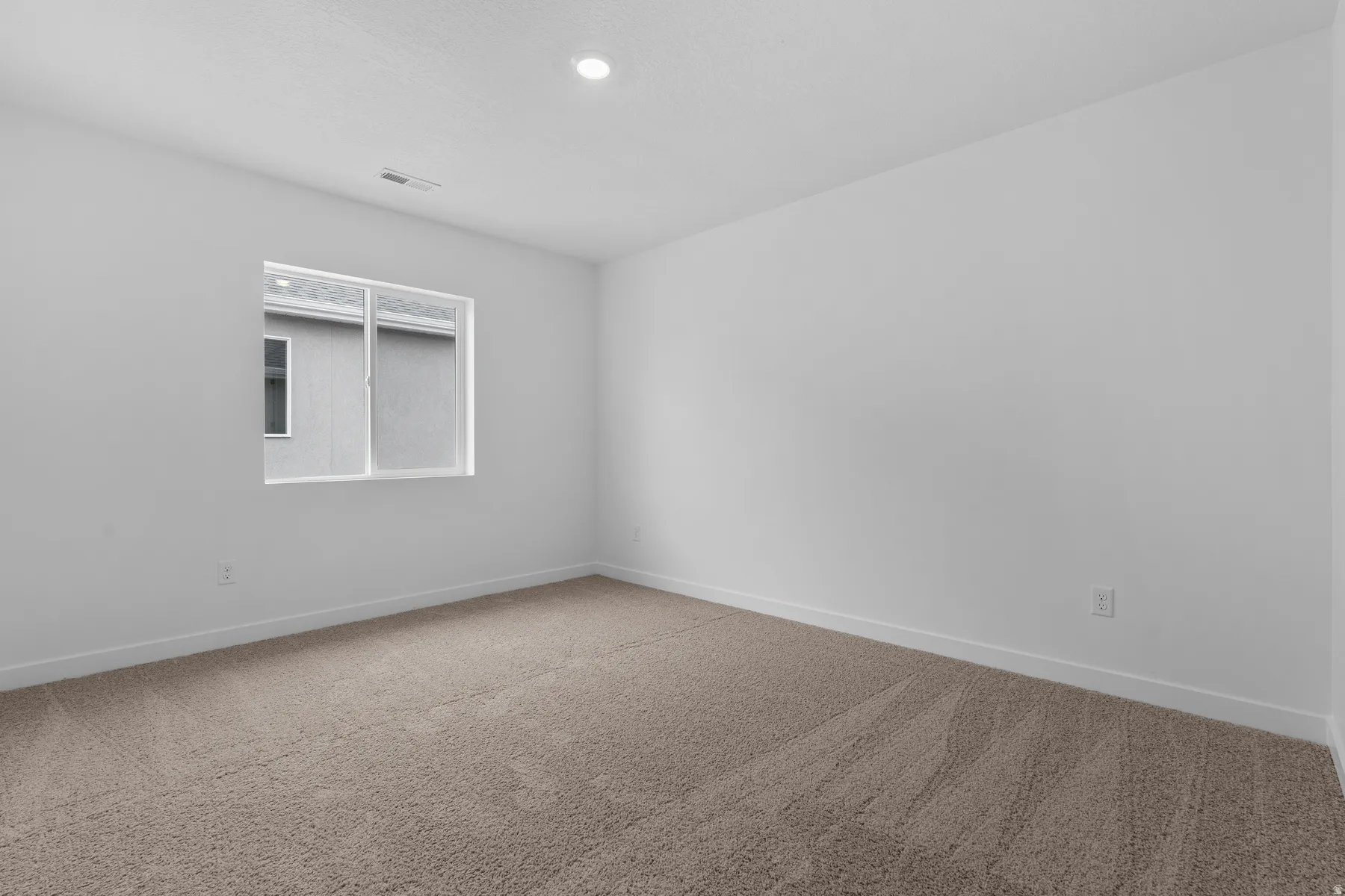 Recessed lighting, neutral wall paint, white trim, and carpeted flooring