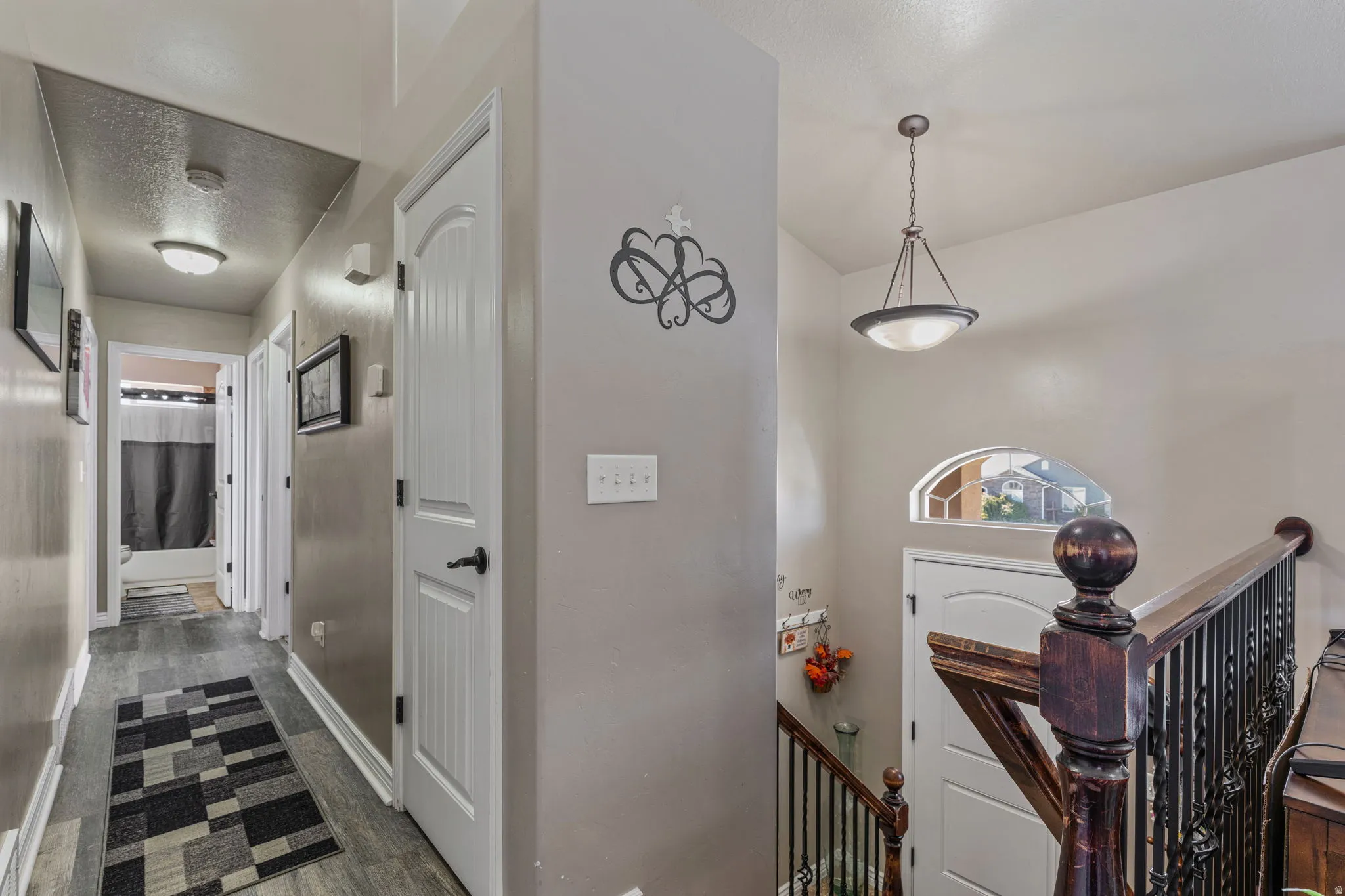 Wood-finish flooring throughout the hallway