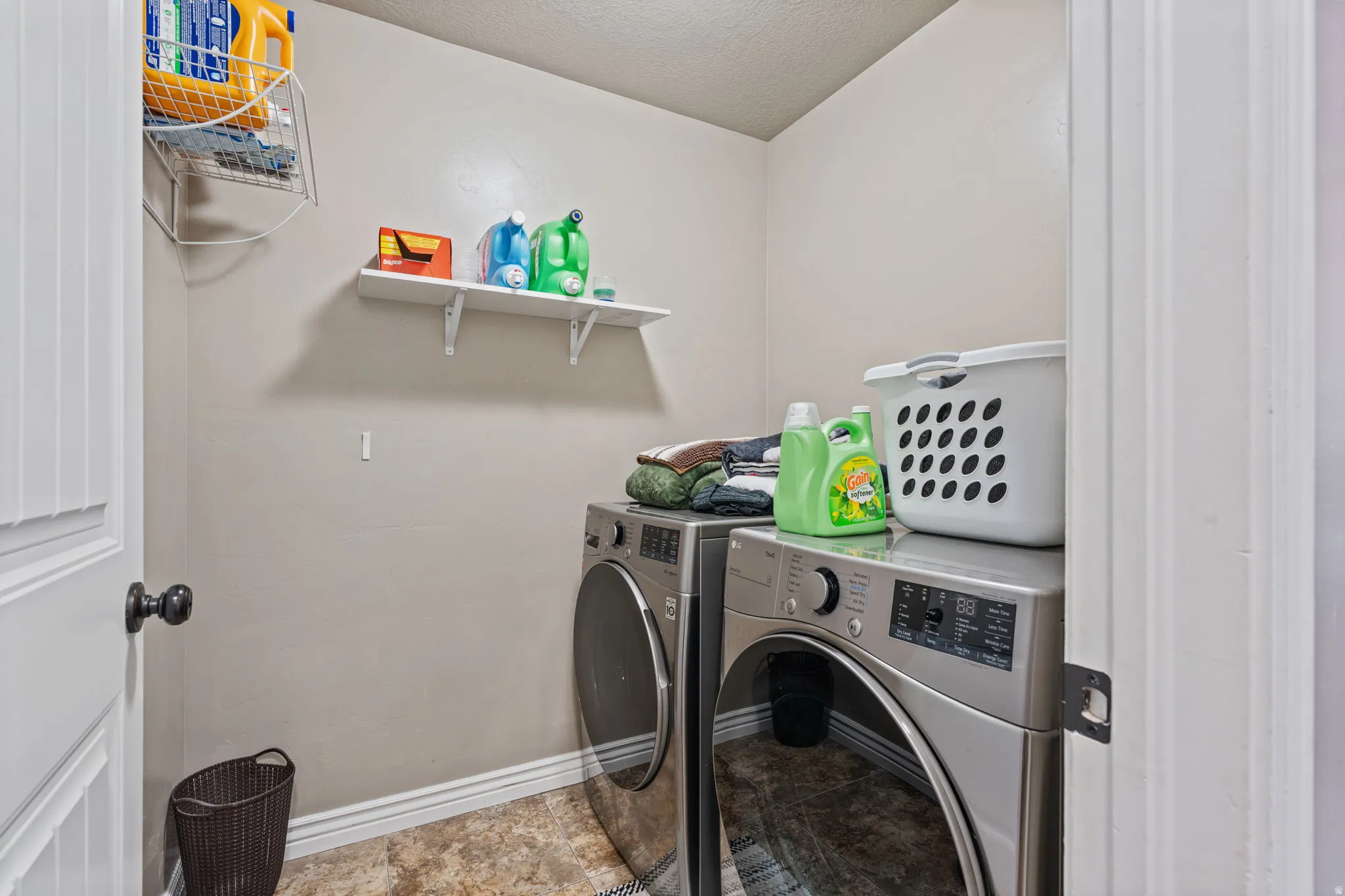 Dedicated utility space featuring wall-mounted shelving and durable flooring