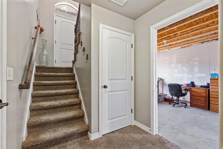Carpeted staircase with a wood-finish handrail