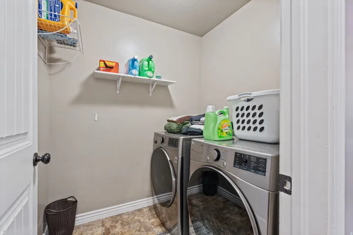 Dedicated utility space featuring wall-mounted shelving and durable flooring