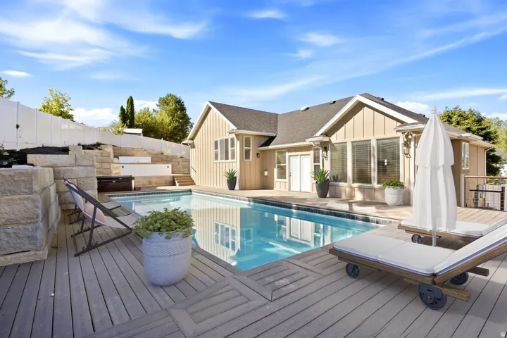 Outdoor swimming pool with a surrounding wood-finish deck