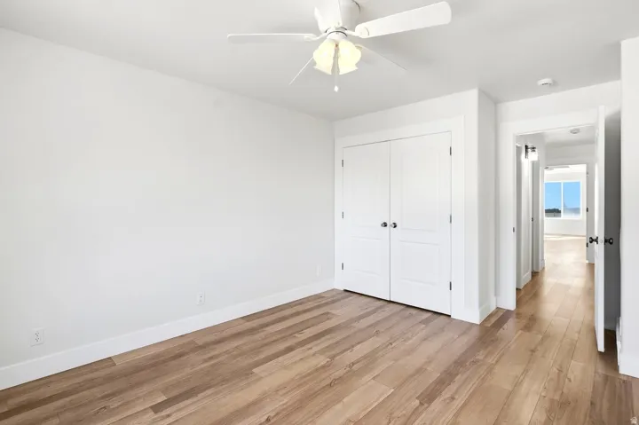 Light wood-finish flooring with white walls