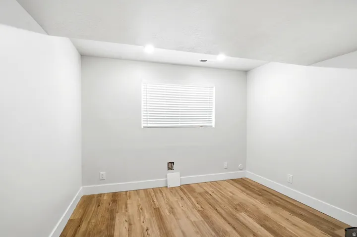 Recessed lighting, wood-finish flooring, and window with blinds