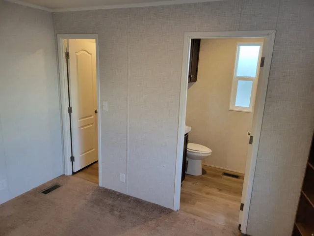 Carpeted flooring, paneled walls, and built-in shelving